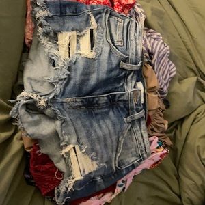 KanCan mid-rise jean short, stylized rips, faded